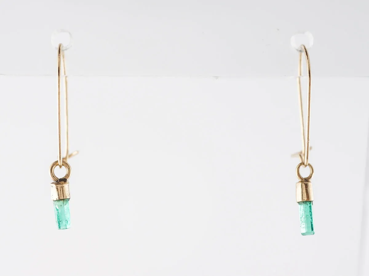 Delicate Emerald Dangle Earrings in 14k Yellow Gold